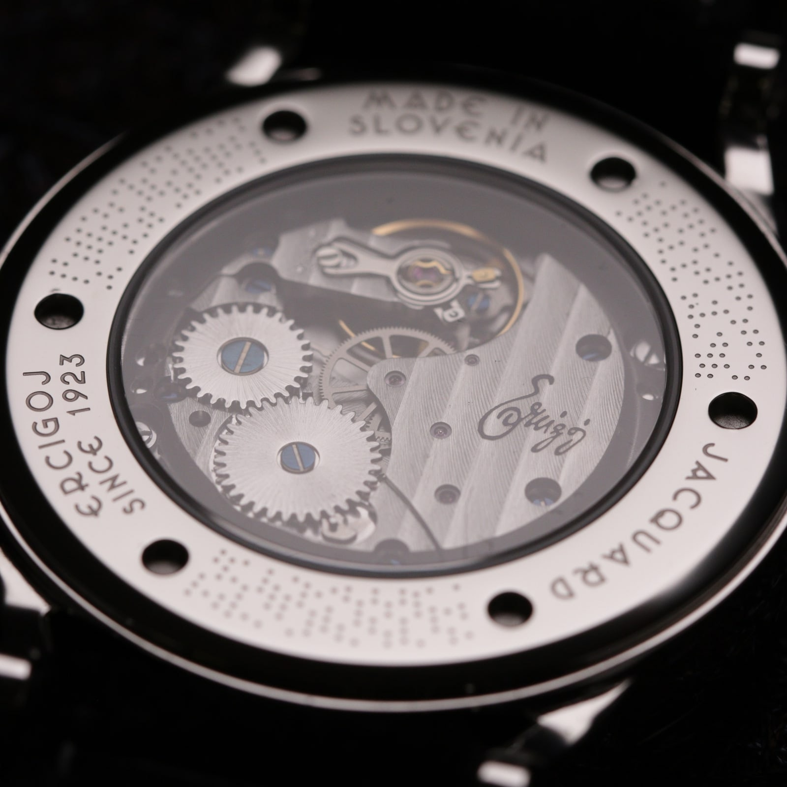 The open case back of JACQUARD, the movement visible, the ring engraved Ercigoj since 1923, JACQUARD, Made in Slovenia