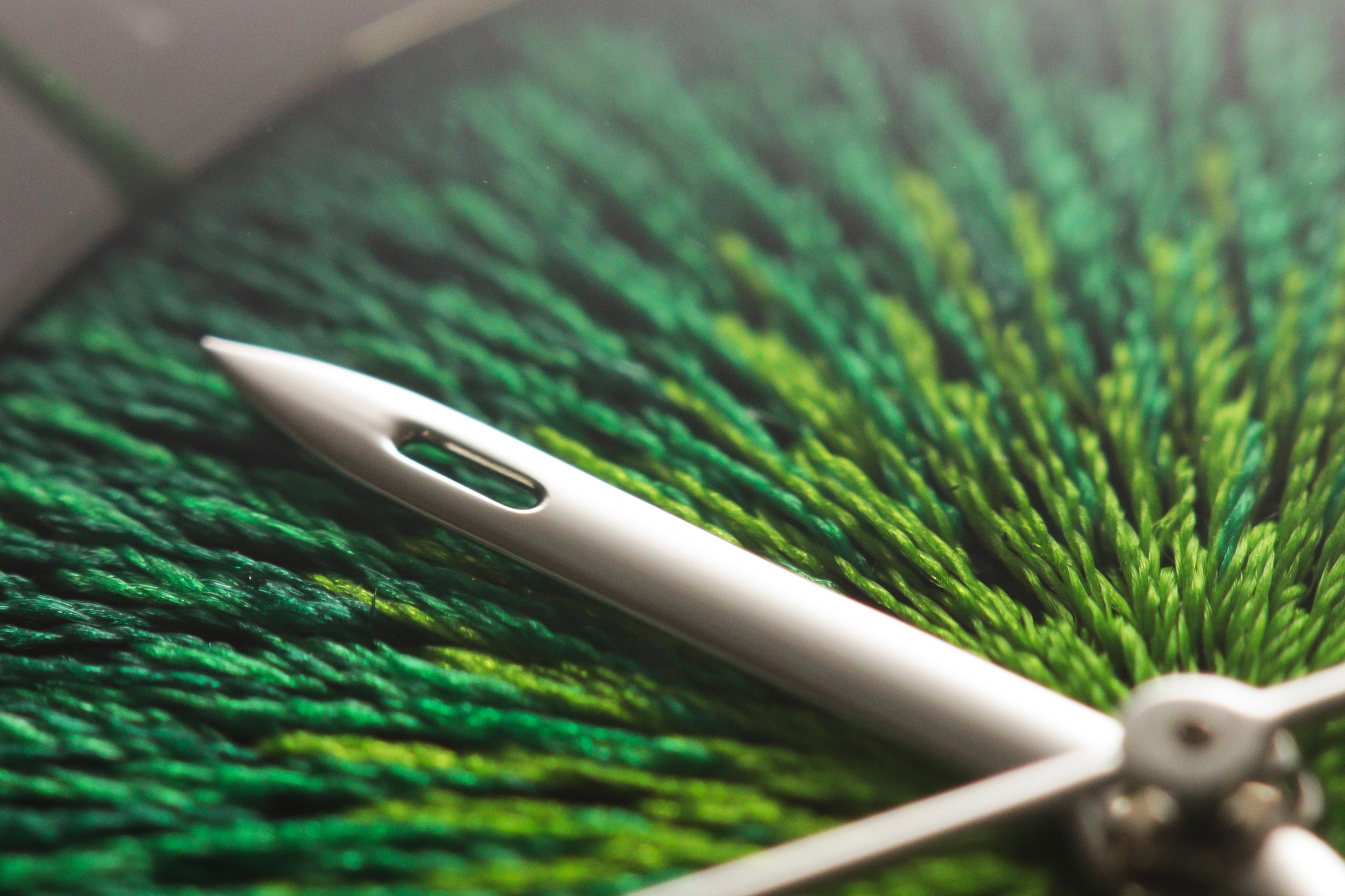 The needle-shaped hand of JACQUARD over its emerald green embroidered dial, seen close
