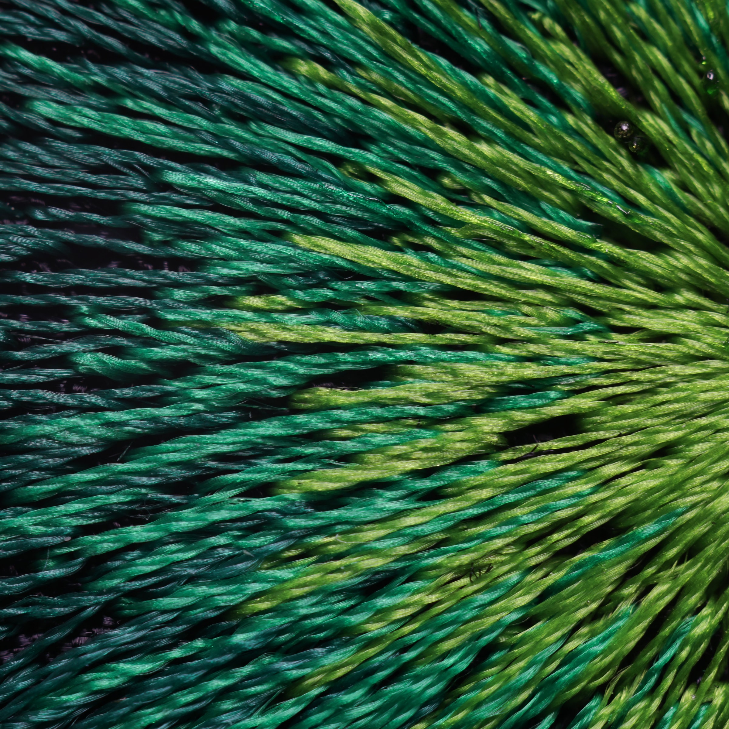 Emerald green threads radiating across the JACQUARD dial, seen very close